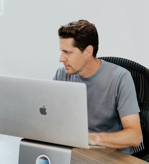 Male worker at his desk working on his computer.