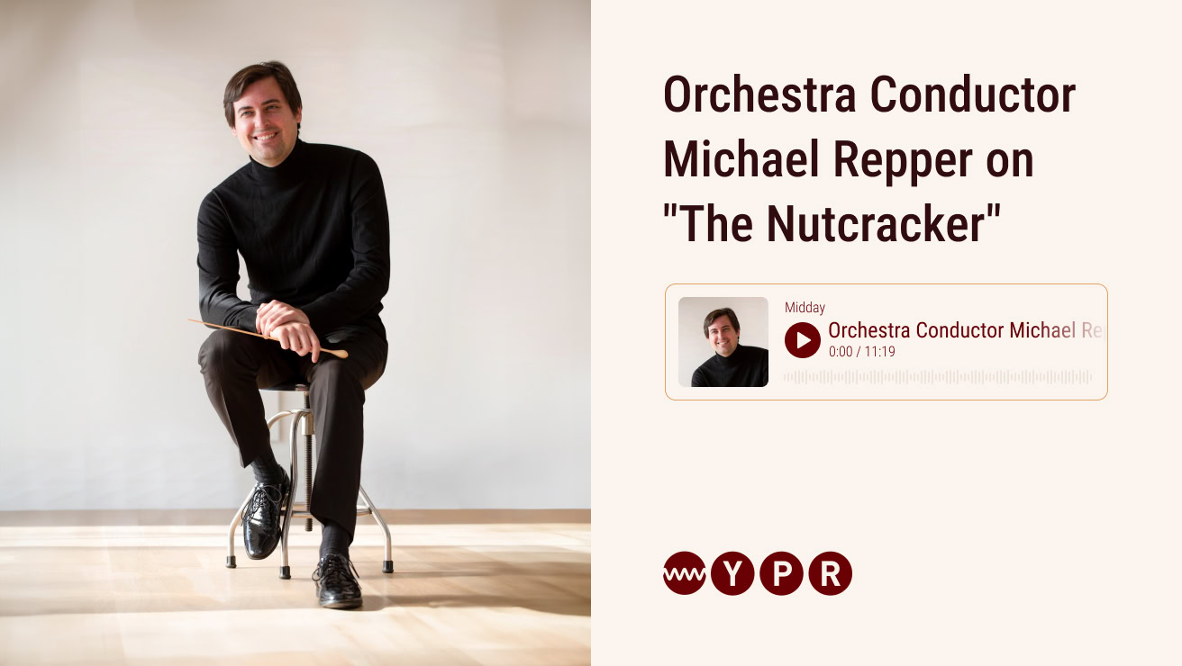 Man in black sitting on a stool smiles in a room with light wood floors, beside a graphic promoting an interview with him titled "Orchestra Conductor Michael Repper on 'The Nutcracker' and a graphic of a podcast player.