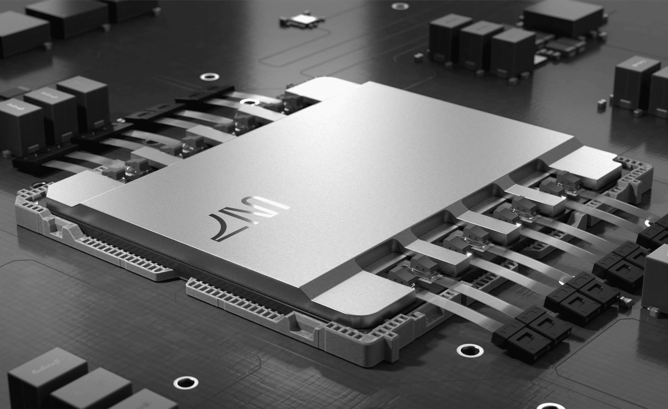 Close-up of a computer microchip on a circuit board, showing a metallic surface with attached connectors and nearby components.