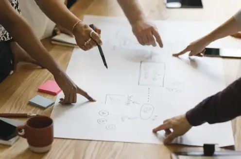 A group of people working on a diagram together.