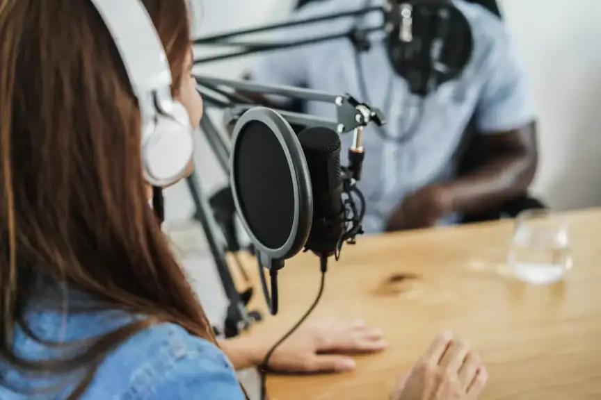 A person wearing a headset and speaking into a microphone.