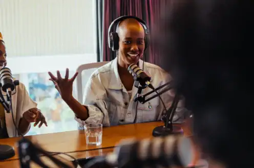 A person wearing headphones and speaking with a microphone.